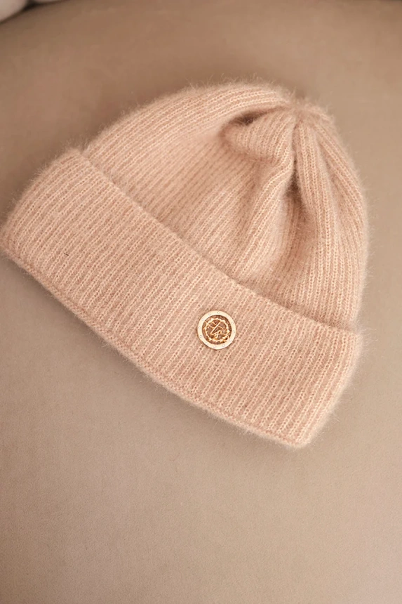Women's winter fluffy hat with decorative button beige