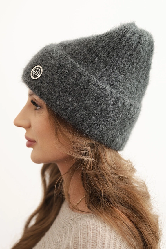 Women's winter hat made of fluffy knit with an elegant button graphite
