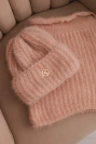Women's set hat and winter fluffy snood with decorative emblem light powder pink