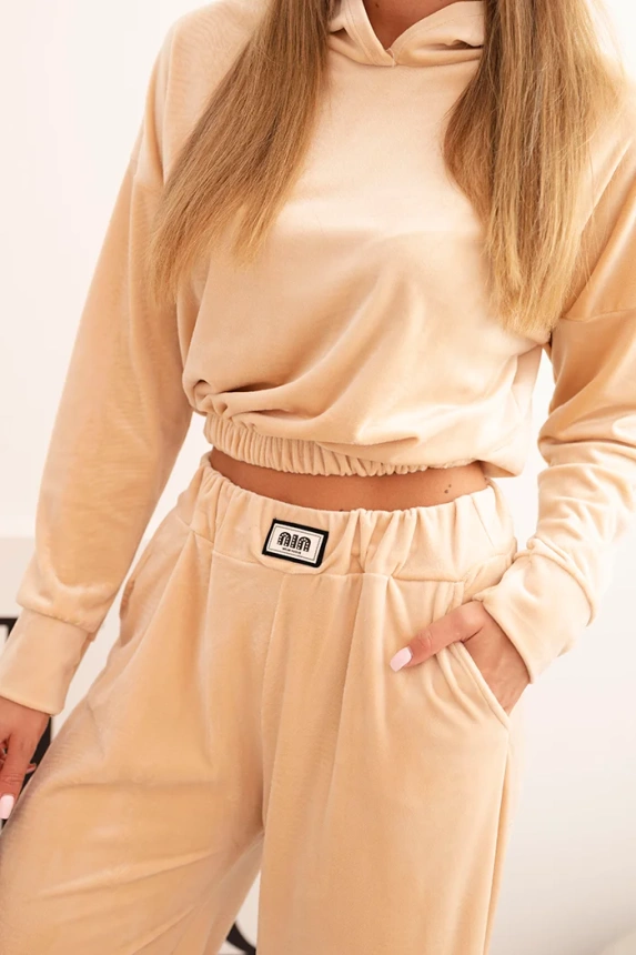 Women's velour tracksuit with wide legs and a hooded sweatshirt beige