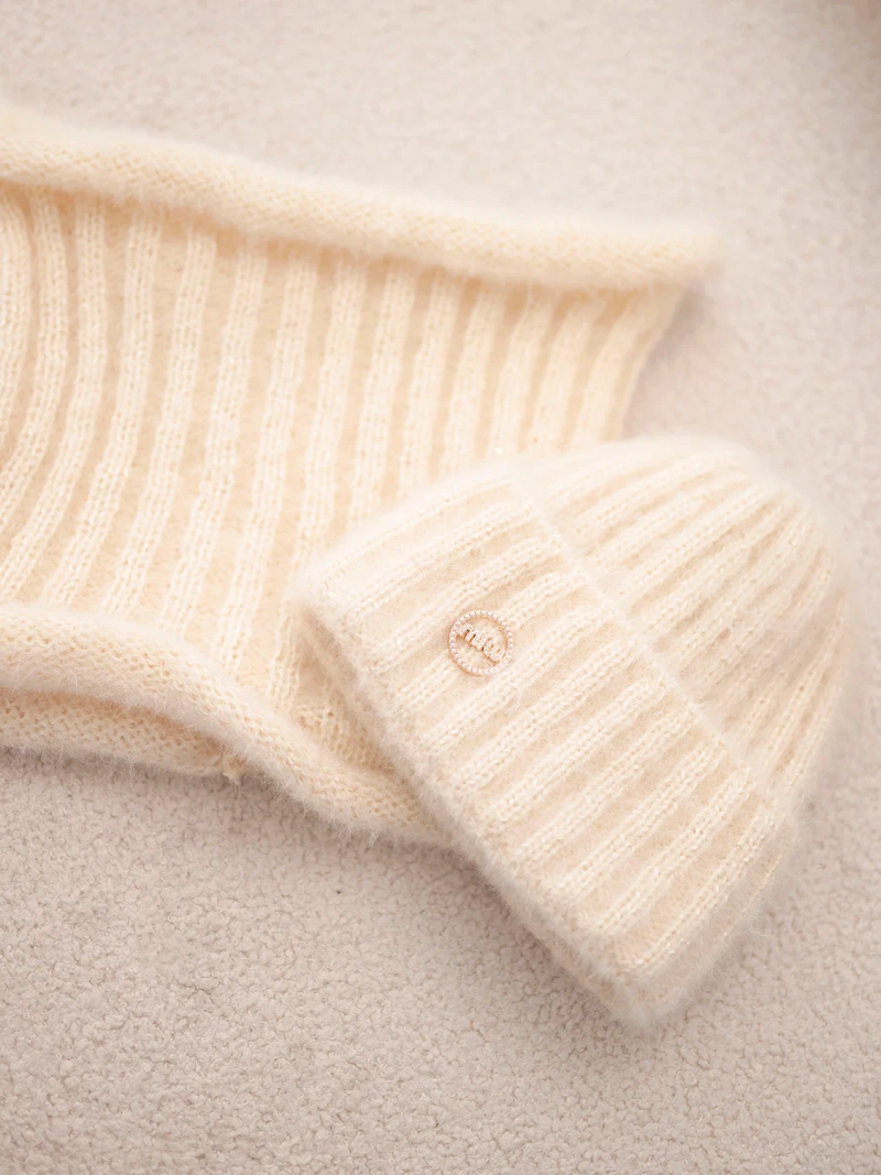 A set women's hat and snood made of knitwear light beige