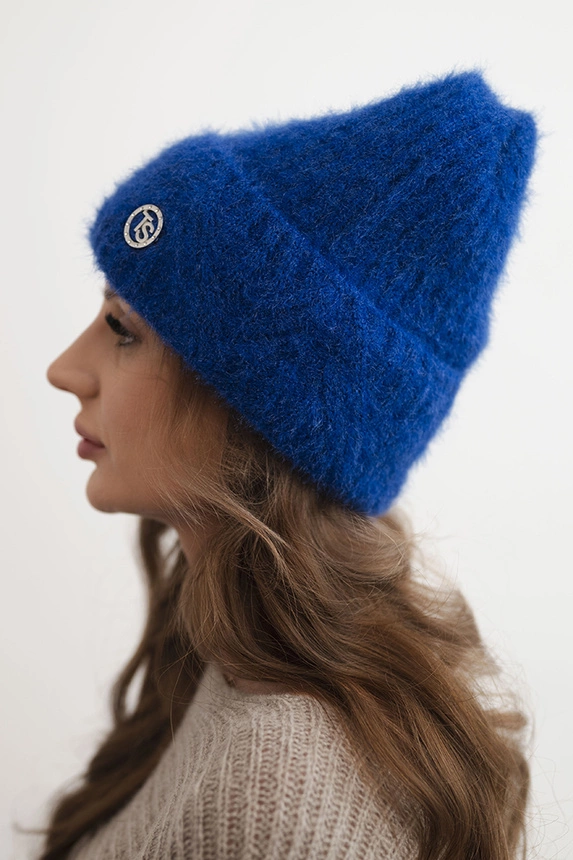 Women's winter hat made of fluffy knit with an elegant button cobalt blue