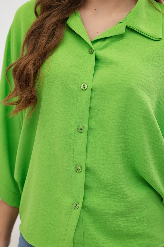 Oversized blouse fastened with buttons bright green