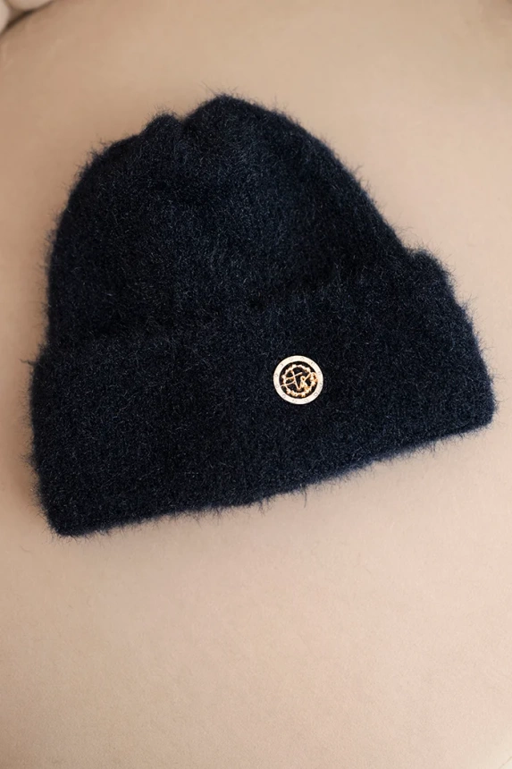 Women's winter fluffy hat with decorative button blue