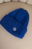 Women's winter hat made of fluffy knit with an elegant button cobalt blue