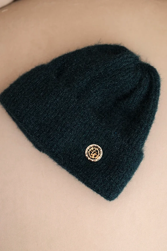 Women's winter fluffy hat with decorative button sea color