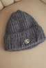 Women's winter hat made of fluffy knit with an elegant button dark gray