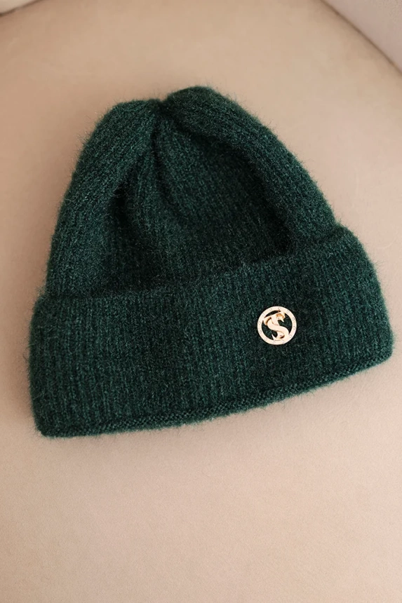Women's winter fluffy hat with decorative button dark green