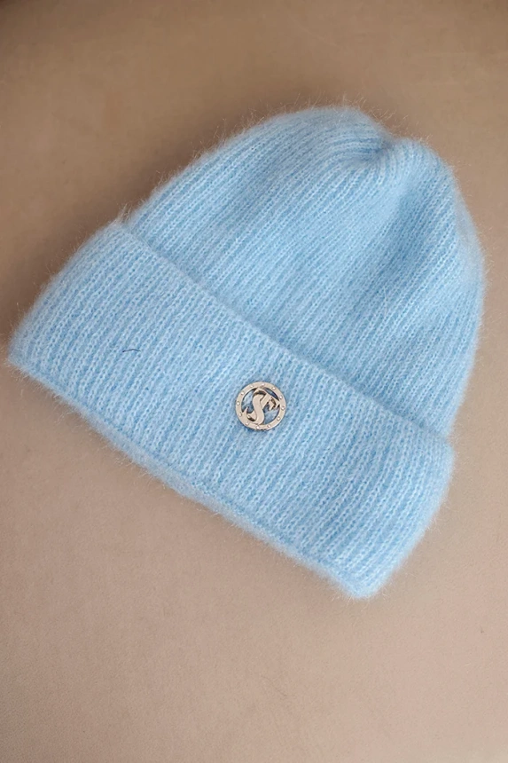 Women's winter fluffy hat with decorative button blue