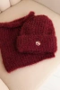 Women's set hat and winter fluffy scarf with decorative emblem burgundy