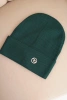 Women's ribbed cap made of modal and viscose with a decorative button dark green