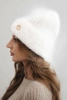 Women's winter hat made of fluffy knit with an elegant button white