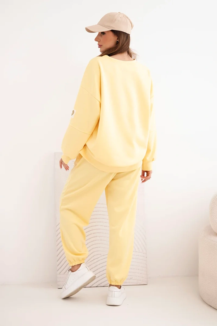 Women's butter-colored set with a loose sweatshirt and pants with the word LOVE yellow