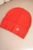 Women's ribbed cap made of modal and viscose with a decorative button red