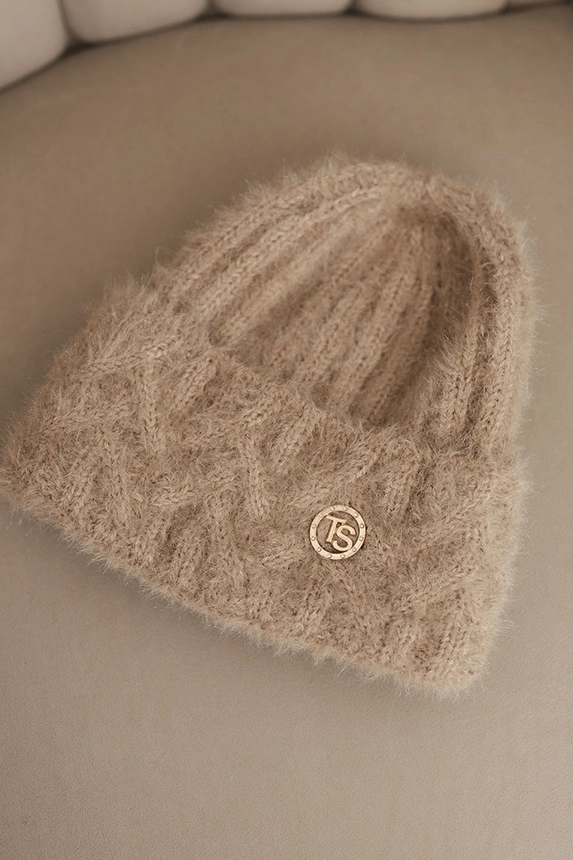Women's winter hat made of fluffy knit with an elegant button beige