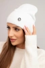 Women's soft hat made of fluffy knit with a decorative plate white
