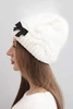 Women's winter hat with a decorative bow and braided pattern K438 ecru