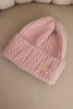 Women's winter hat made of fluffy knit with an elegant button powder pink