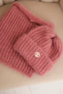 Women's set hat and winter fluffy snood with decorative emblem dark pink