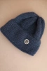 Women's winter fluffy hat with a decorative button denim color