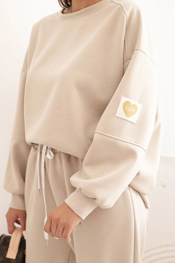 Ladies' butter set with a loose sweatshirt and pants with the word LOVE beige