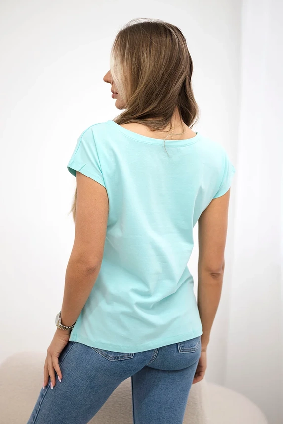 Mintfarbene Bluse mit Lippendruck