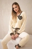 Velour set with a decorative brooch light beige