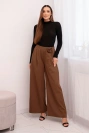 Elegant women's trousers with wide legs and a decorative flower light brown
