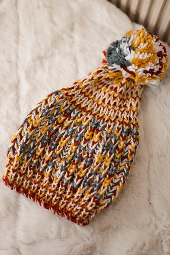 Cap with a pompom Maria K335 mustard