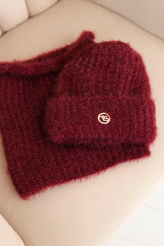 Women's set hat and winter fluffy scarf with decorative emblem burgundy