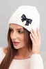 Women's winter hat with a decorative bow and braided pattern K438 ecru