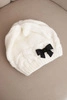 Women's winter hat with a decorative bow and braided pattern K438 ecru