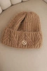 Women's winter hat made of fluffy knit with an elegant button camel