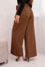 Elegant women's trousers with wide legs and a decorative flower light brown