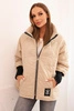 Quilted women's jacket with a short cut and a stand-up collar dark beige