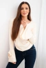 Women's ribbed blouse with a V-neck and ruffles on the sleeves beige