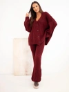 A women's knitted set with a cardigan and wide trousers burgundy