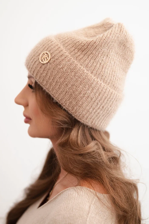 Women's winter fluffy hat with a decorative button light camel