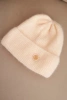 Women's winter fluffy hat with decorative button melon