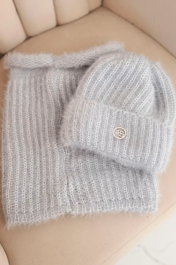 Women's set hat and winter fluffy scarf with decorative emblem gray