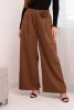 Elegant women's trousers with wide legs and a decorative flower light brown